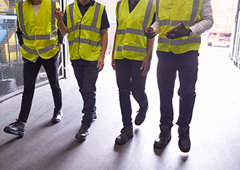 Employees in yellow reflective safety vests