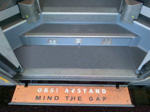 Orange Anti-Slip covers on steps reads "mind the gap"