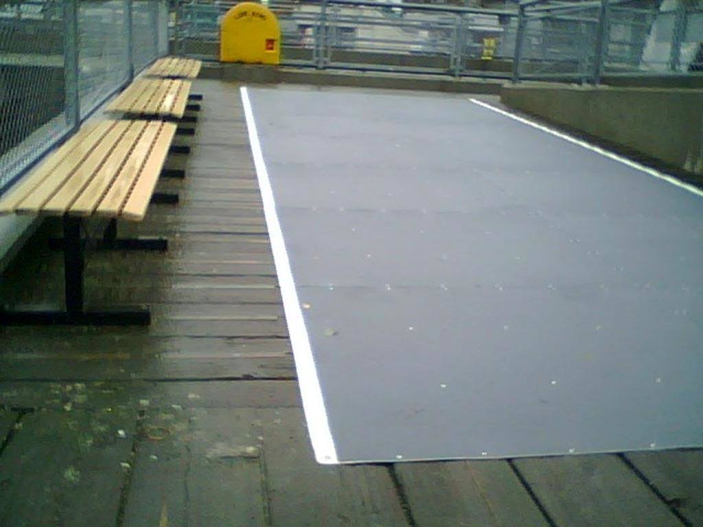Black Walkway cover with white edge on wooden walkway