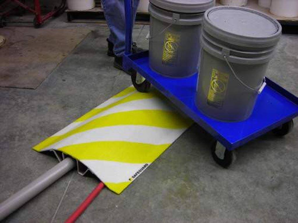 image-17 yellow and white striped Pipe cover at facility with cart going over